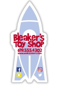 Custom shaped rocket magnet featuring Bleaker's Toy Shop in red lettering, contact information, and social media icons.